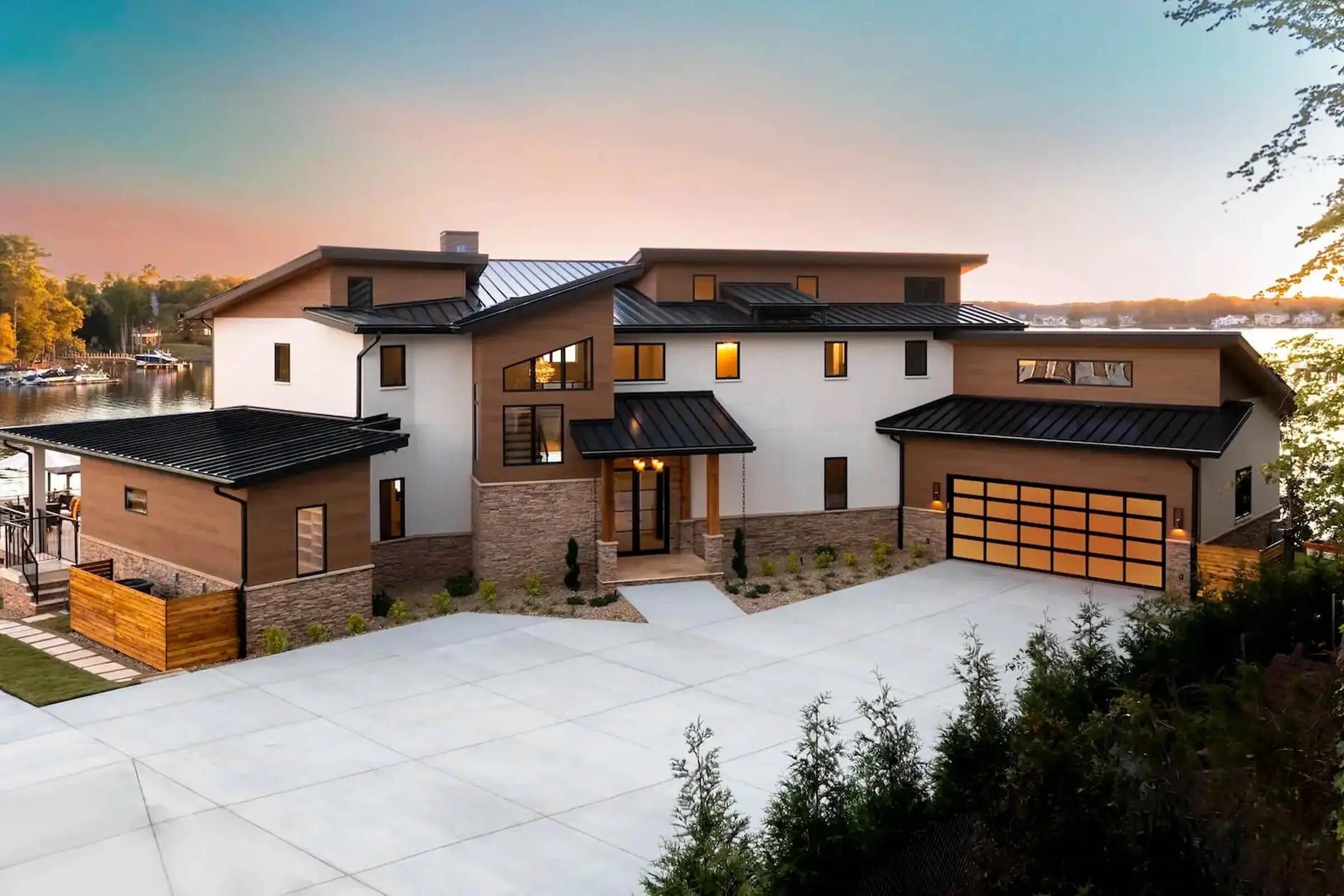 Modern lakeside house at sunset.