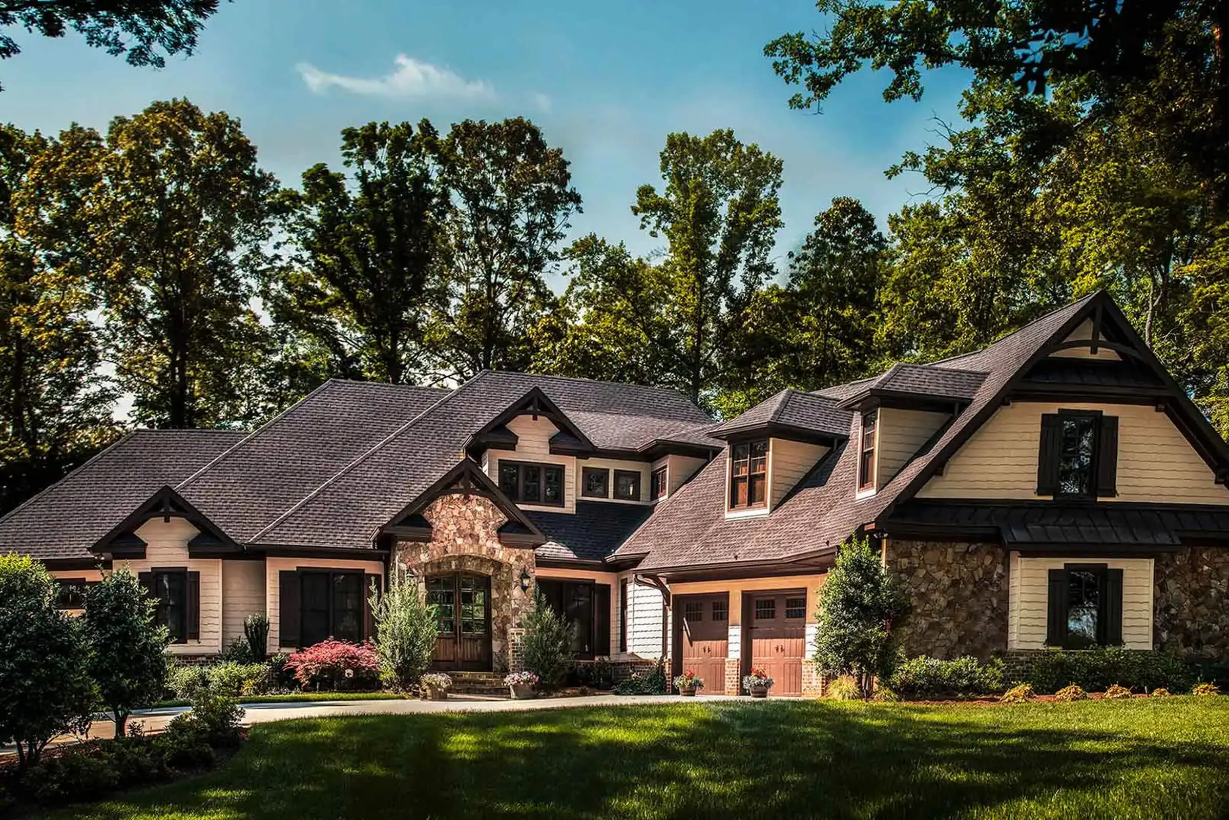 Large house surrounded by trees and shrubs.