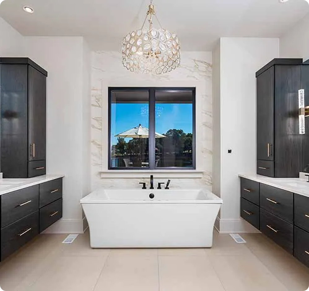 image-2 Luxury bathroom with freestanding tub and chandelier.