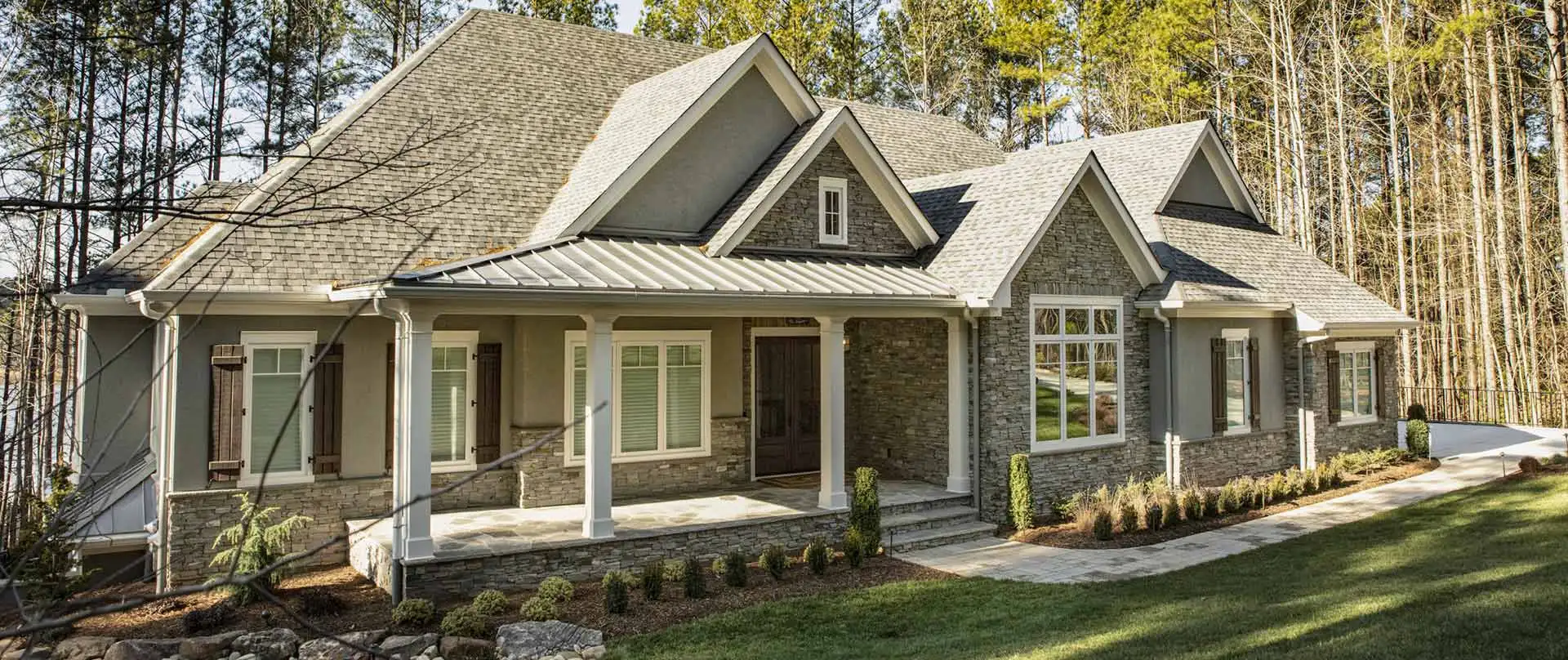 Single-story stone house with pitched roof.