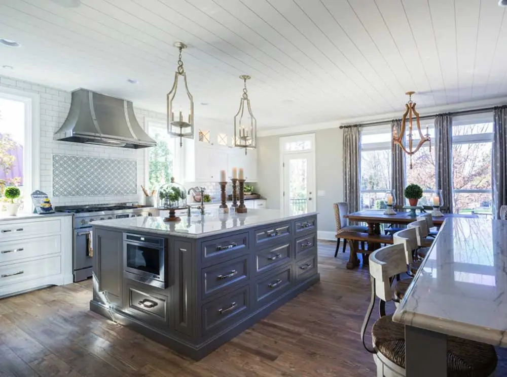 Modern kitchen with large island and seating.