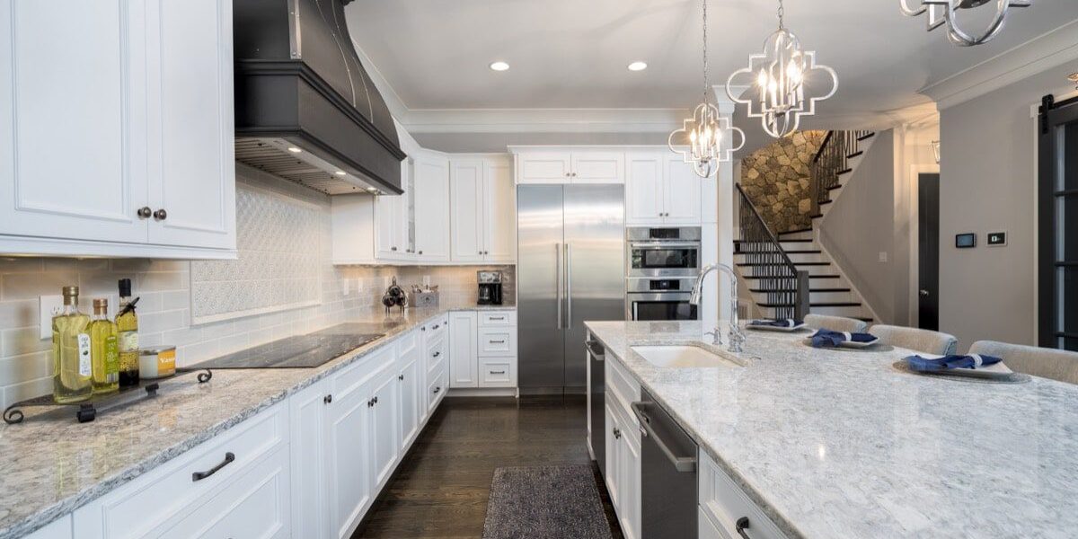 Modern kitchen with white cabinets and island.