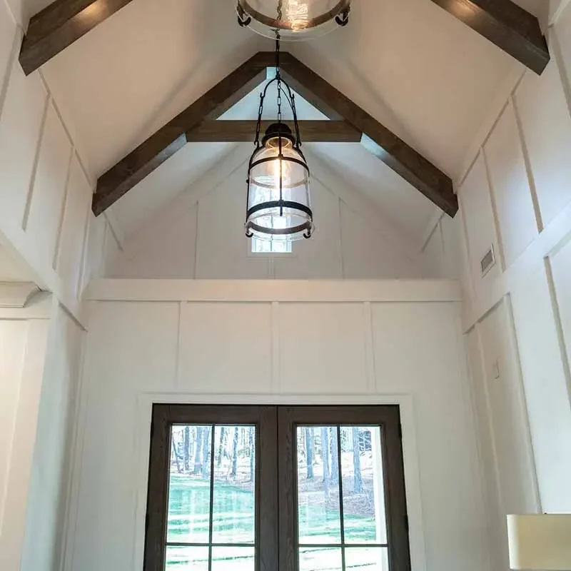 Custom-Home-Builder-Cozy-Lake-House-Entry Vaulted ceiling entryway with hanging lights.