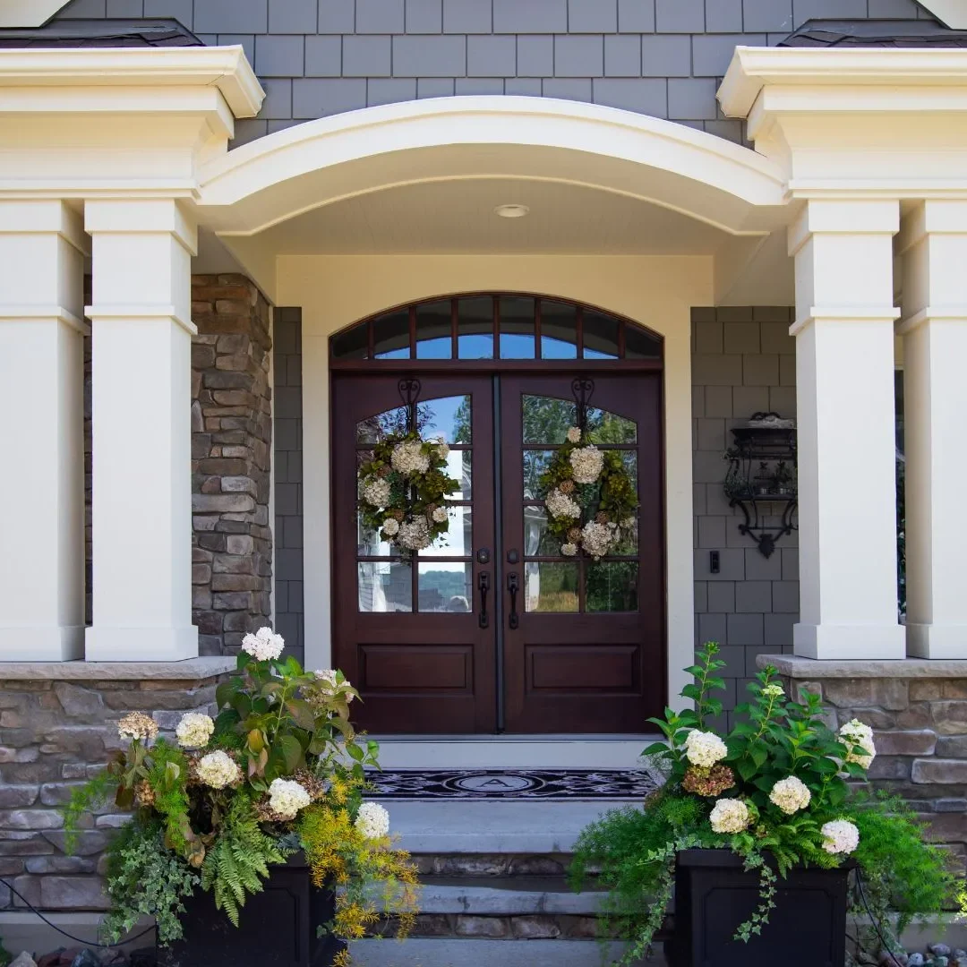 Hear-What-Our-Clients-Have-to-Say_-Keyston-Building-Group Elegant house entrance with decorative plants.