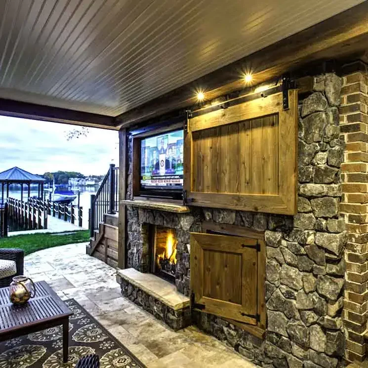 keystone-building-group-custom-home-builder-outdoor-living-5 Cozy patio with fireplace and lake view.